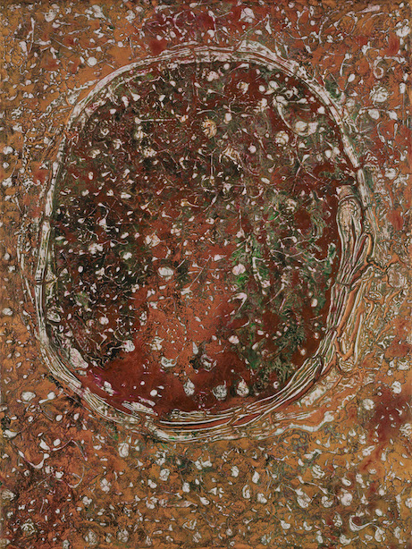 White orb set amid pebbles in a dry desert background of gold red and dark green.